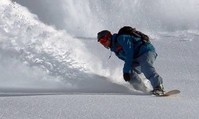 Snowboarder and snow spray