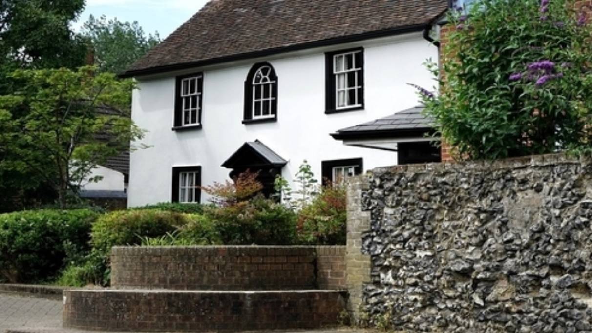 Big cottage white white walls and black window 