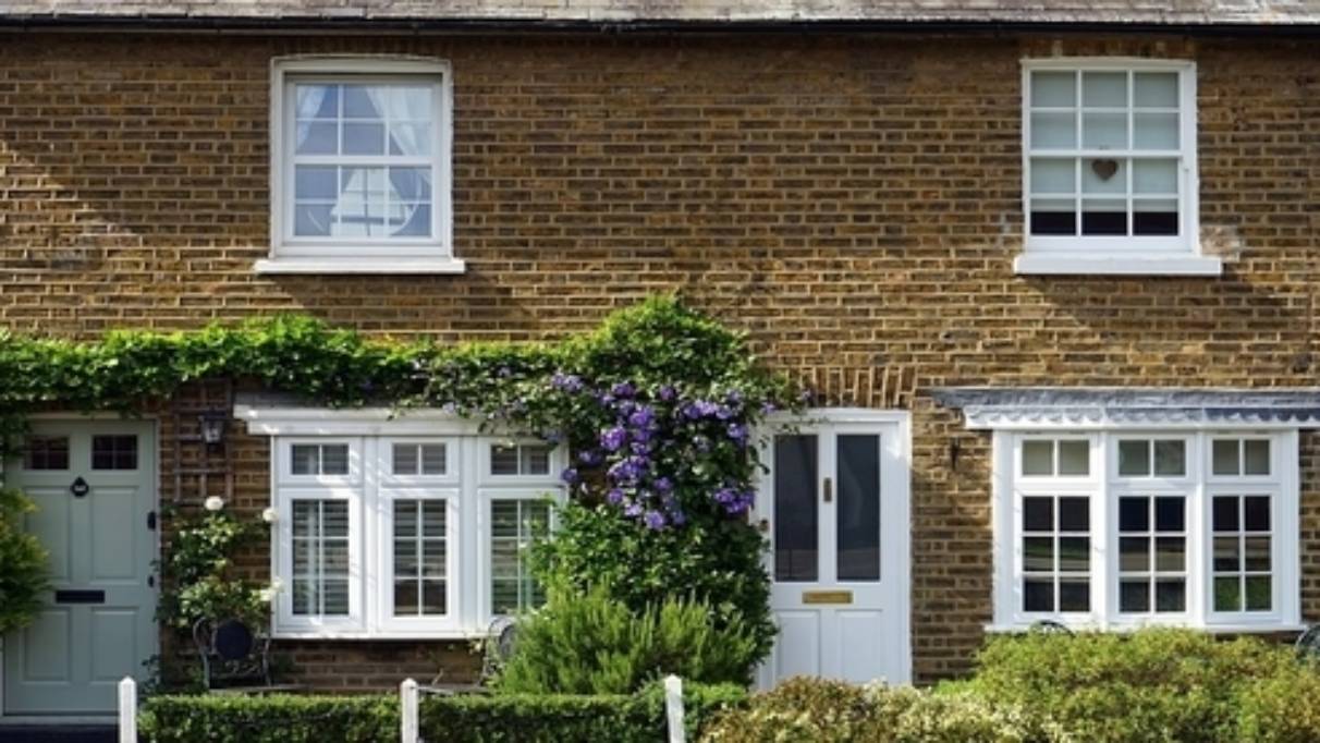 semi detached house with green plat above the window and door