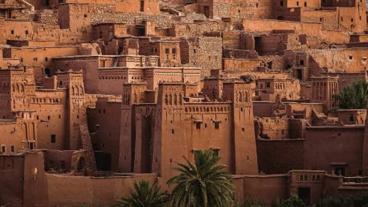 Ait Ben Haddou, a brown dessert stone hillside city in Morocco