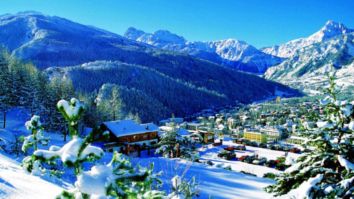 a mountain village nestled in a snowy valley
