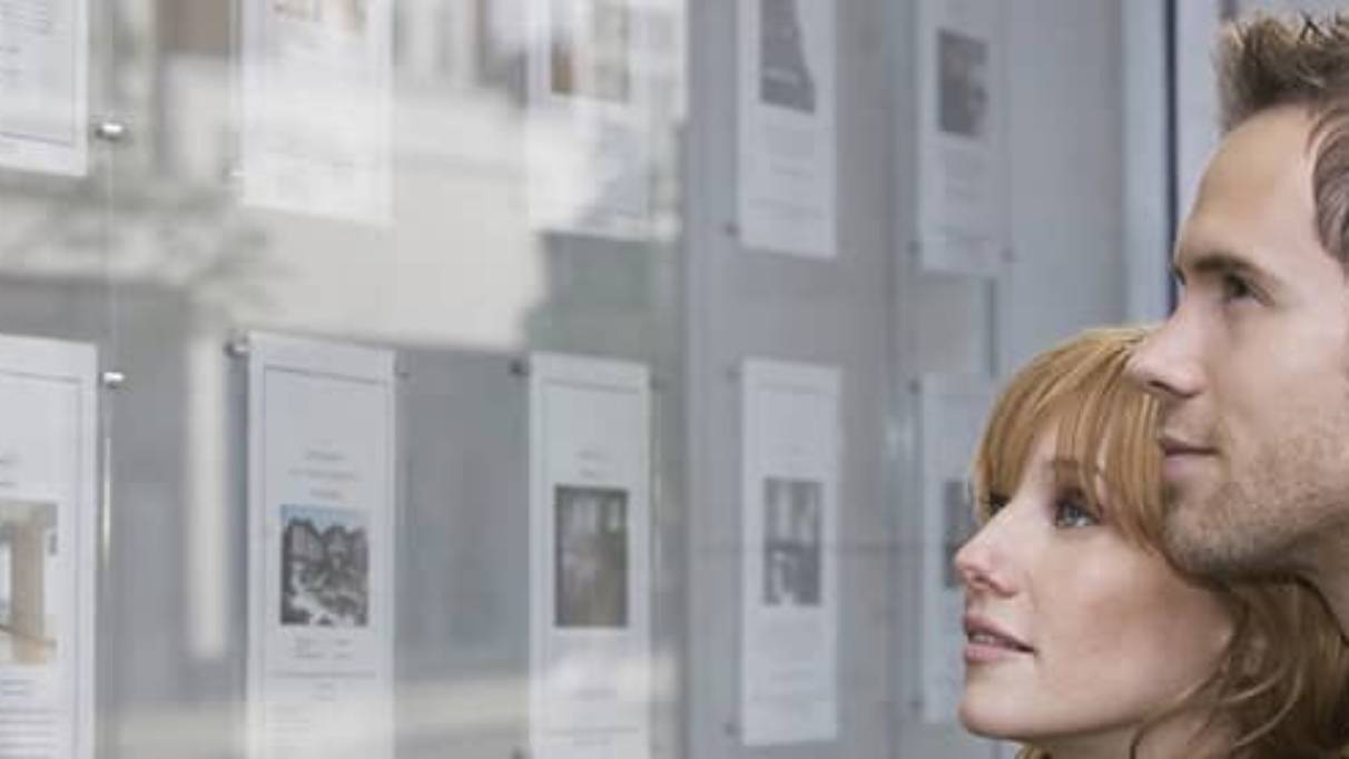 Young couple looking ad house listings