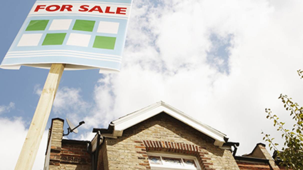 For sale Board in front of a house