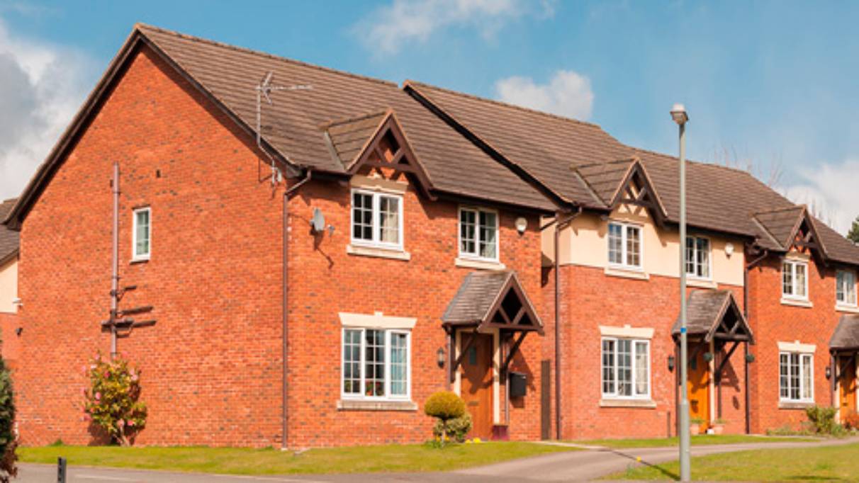 Row of houses on left side of a short road