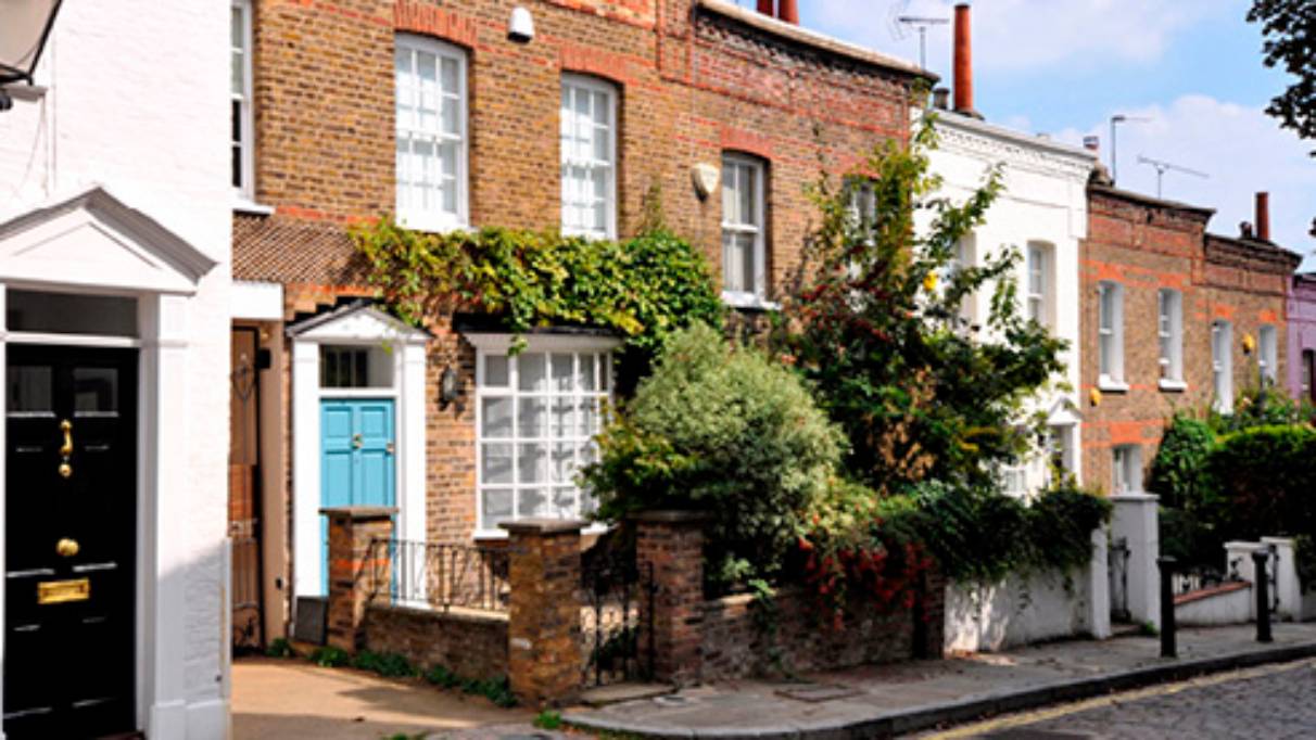 street view of houses with trees and street lamp