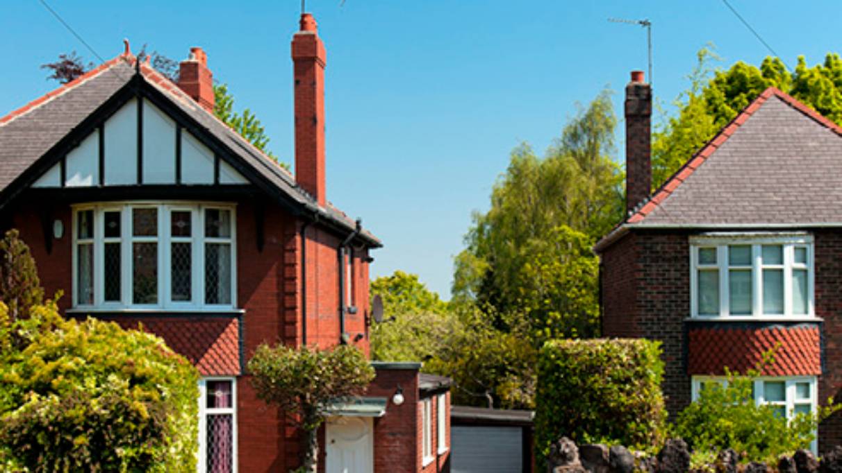 two Detached houses with lots of green around