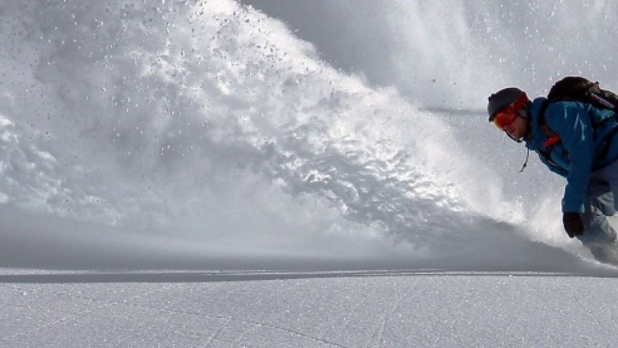 Snowboarder and snow spray