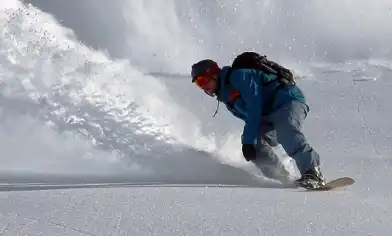 Snowboarder and snow spray