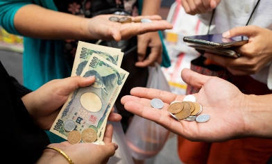 People holding various currencies