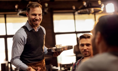 Waiter having a chat with a customer