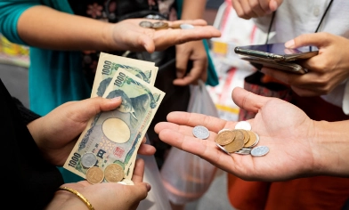 People holding various currencies